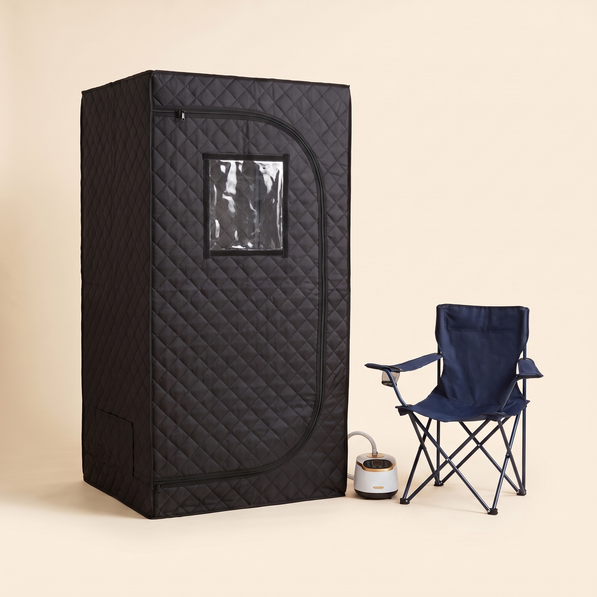 Portable steam sauna kit front view with folding chair and steamer on a cream studio background