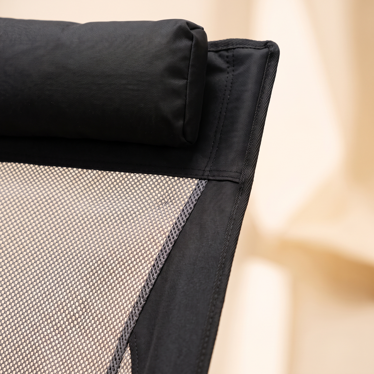 Close up of the headrest and breathable mesh panel on the high back camping chair