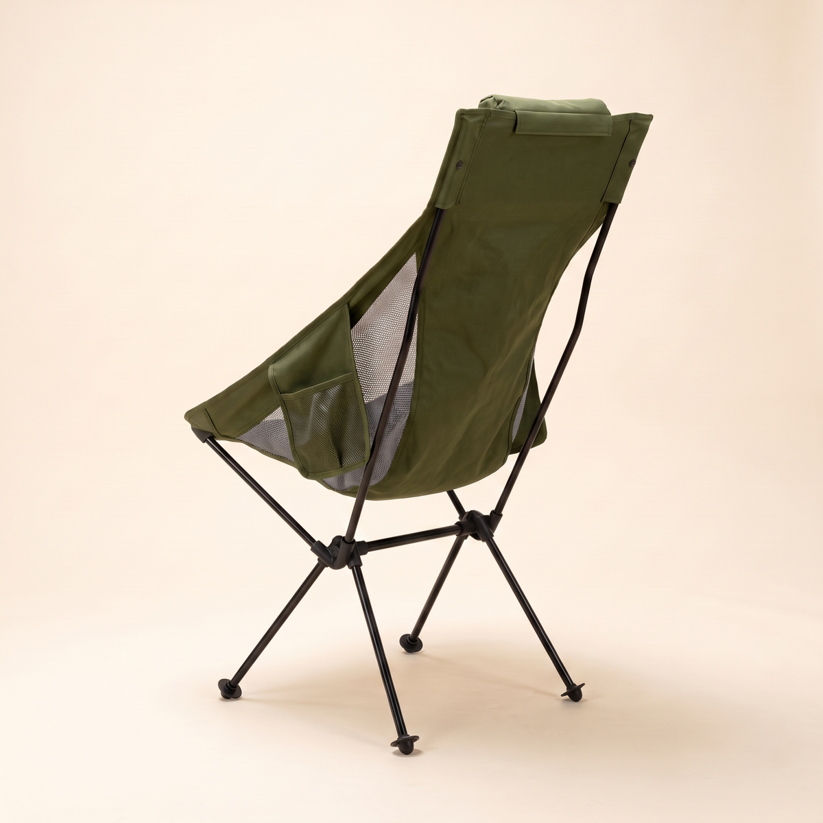Ultralight high back camping chair in olive with headrest pillow on a cream studio background