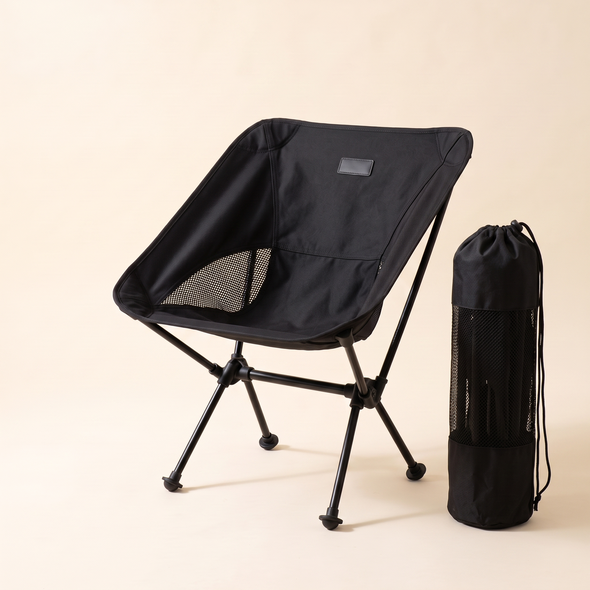 Compact folding camping chair beside its carry bag