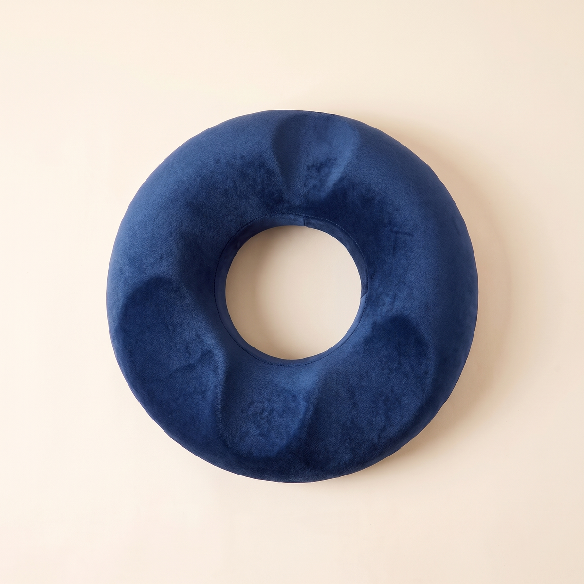 Top view of the memory foam donut seat cushion in navy blue