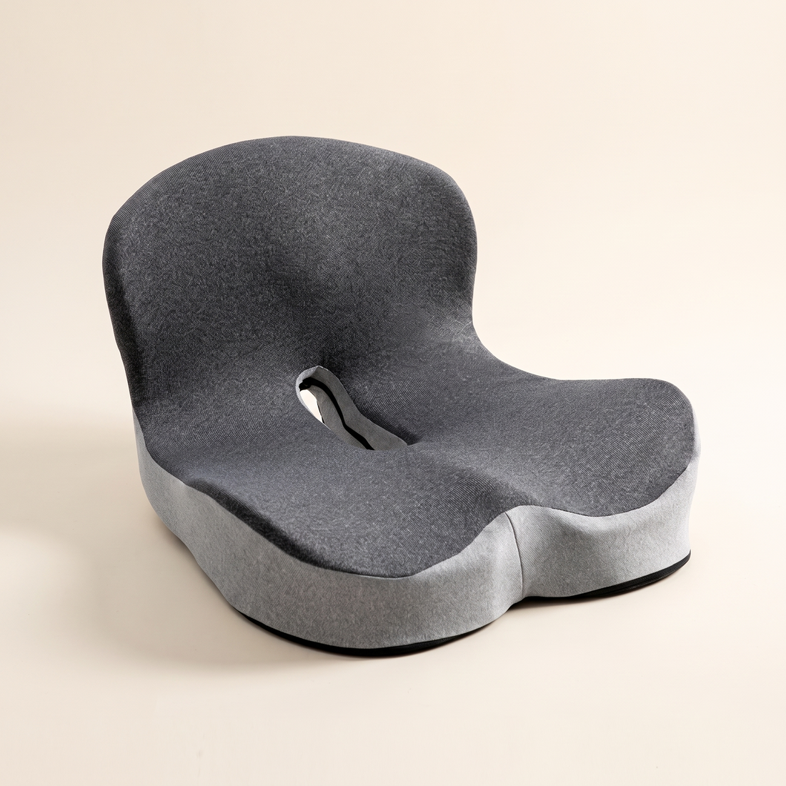 Ergonomic memory foam seat cushion with backrest in color blocked gray knit on a cream studio background