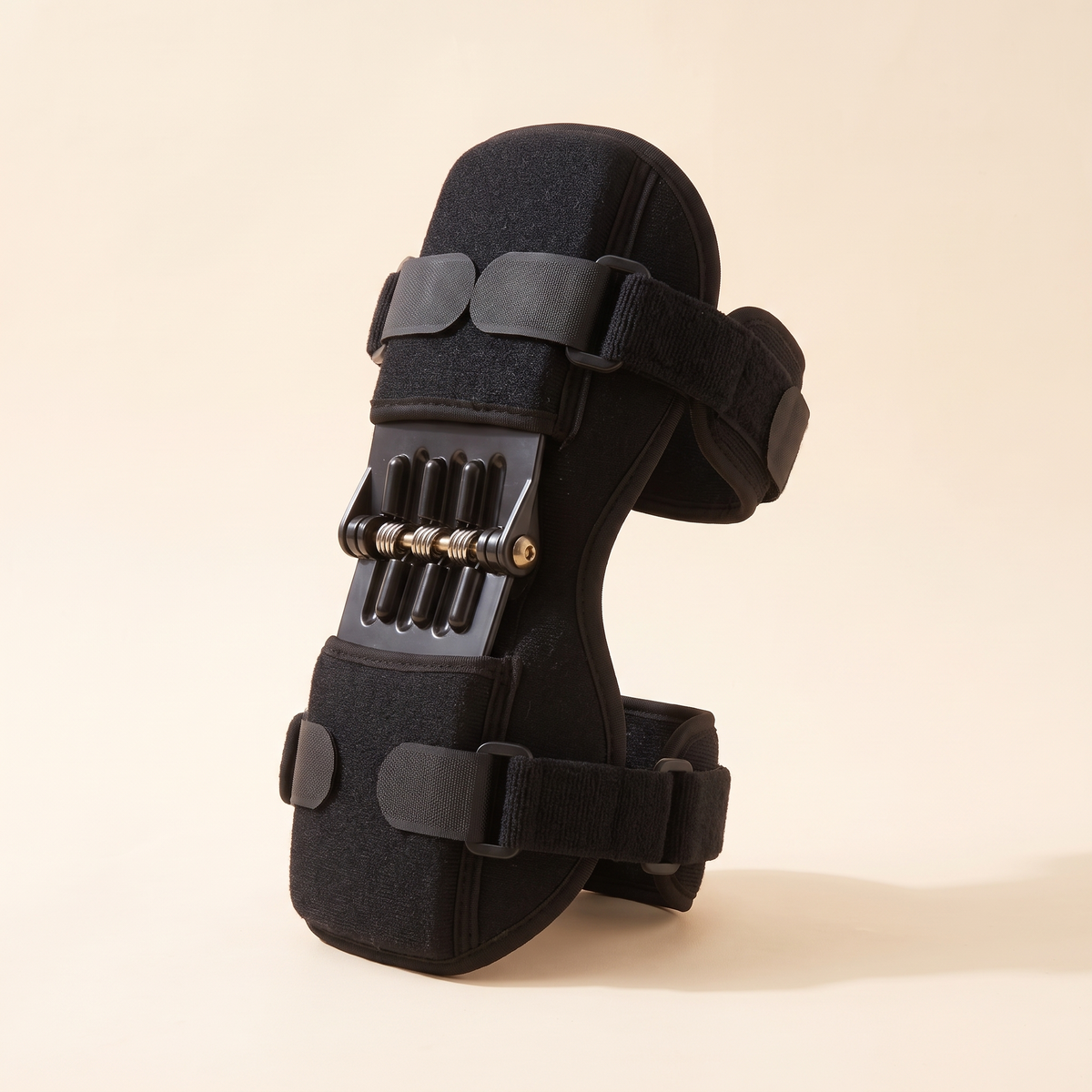 Black spring support knee brace seen from the side showing the spring stabilizers