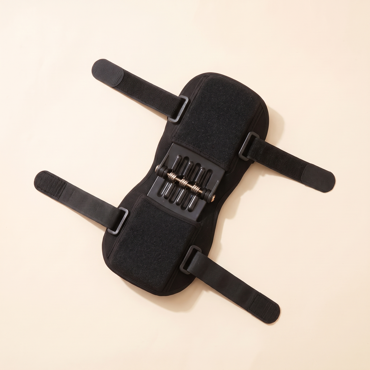 Black knee brace laid flat with the hook and loop straps opened out