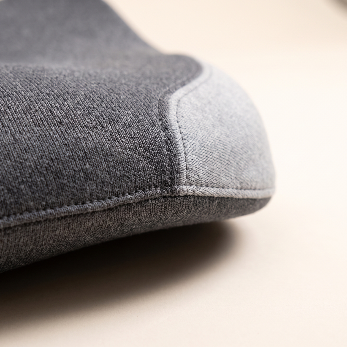 Close up of the knit fabric and stitched edge of the seat cushion