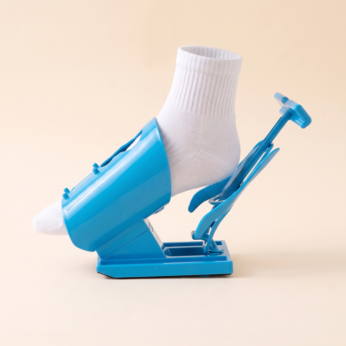 Side view of the blue sock aid showing the molded sleeve and pull handles