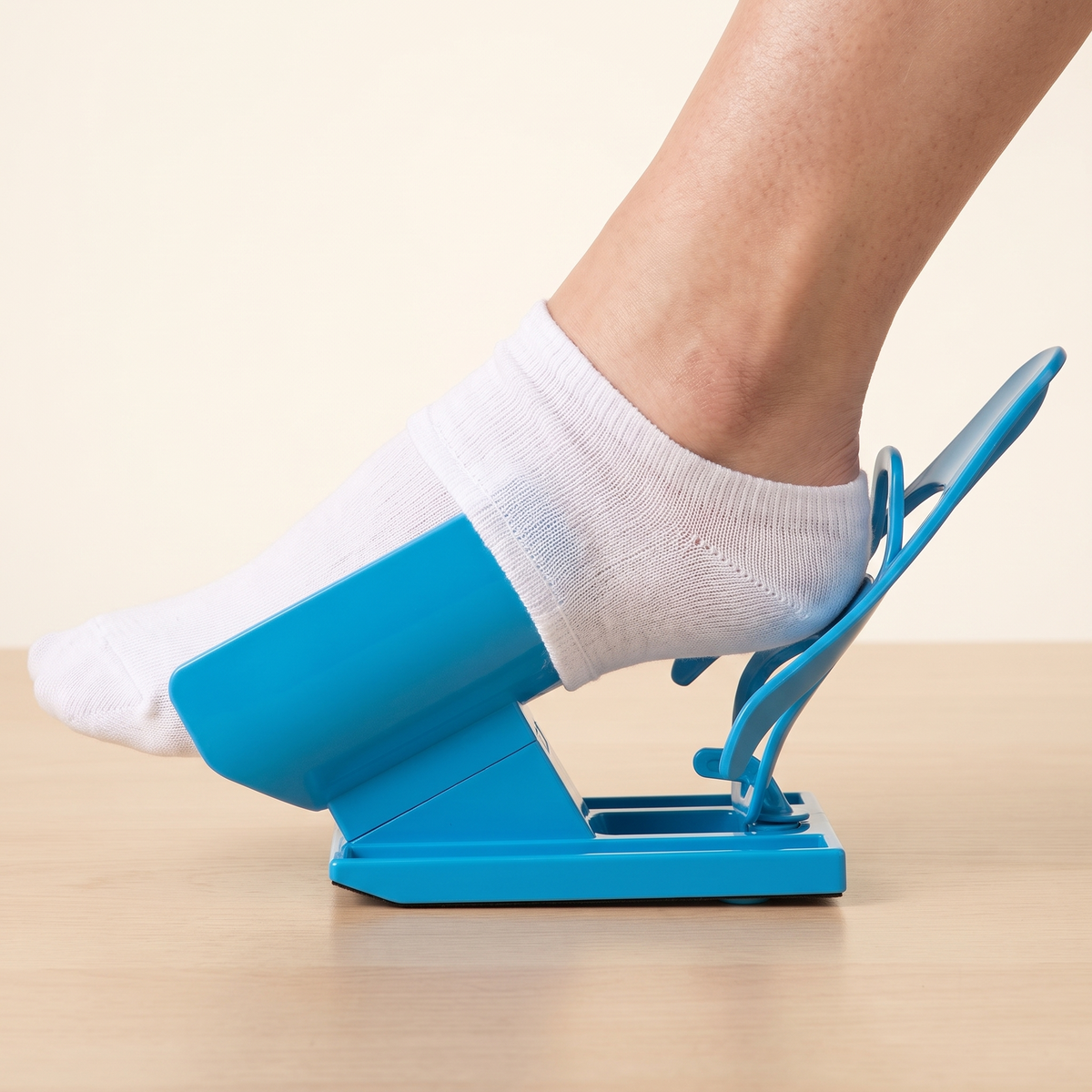 Side view of a foot inside the sock covered sleeve of the sock puller assist